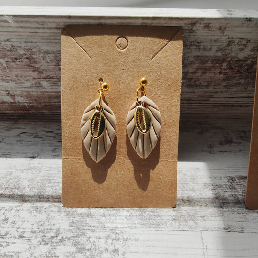 Leaf dangle earrings with cowrie shell